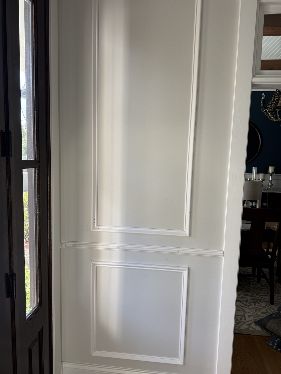 Shadowbox wainscoting above and below the chair rail in a Hallsley foyer in Midlothian, VA
