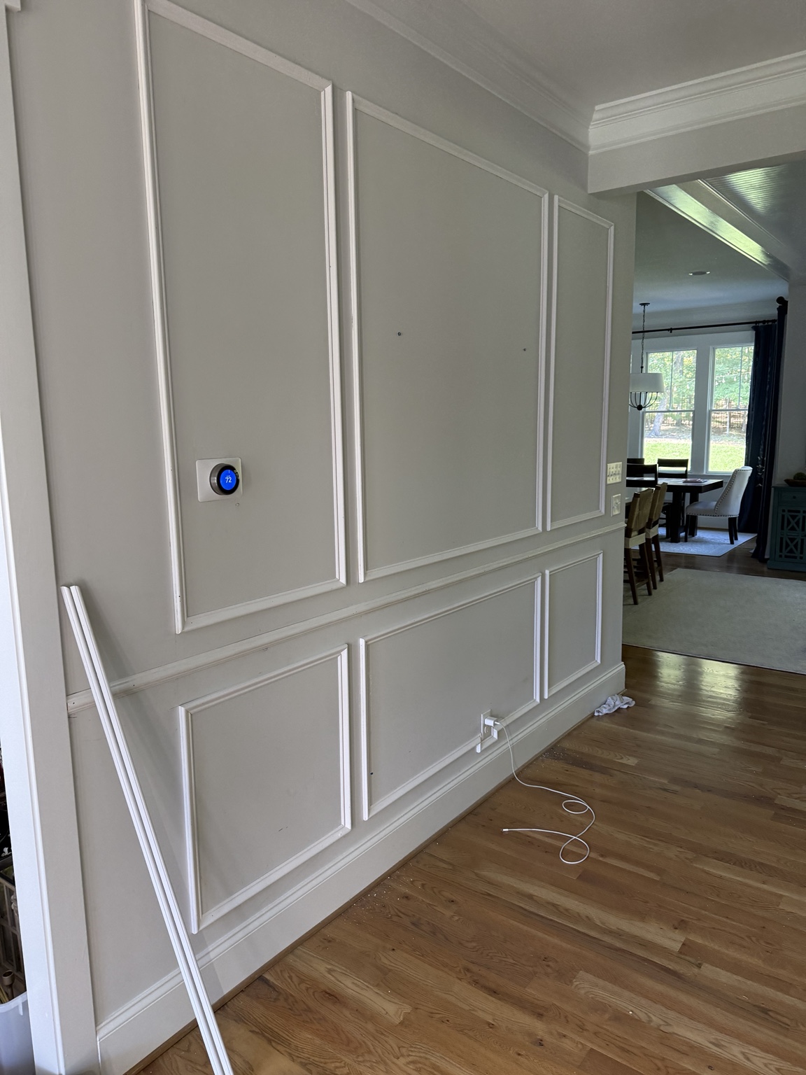 Shadowbox wainscoting above and below the chair rail in a Hallsley foyer in Midlothian, VA