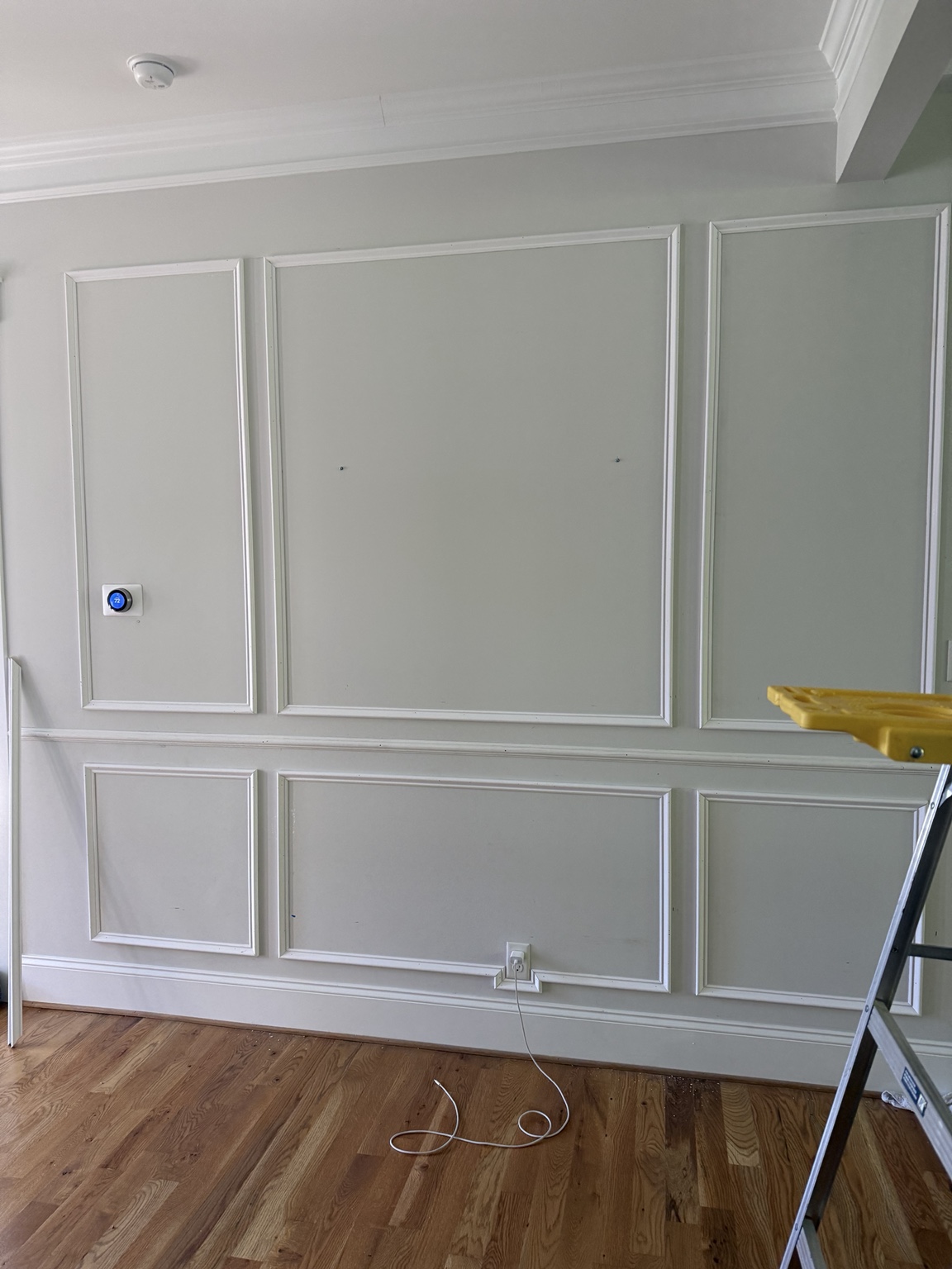 Shadowbox wainscoting above and below the chair rail in a Hallsley foyer in Midlothian, VA