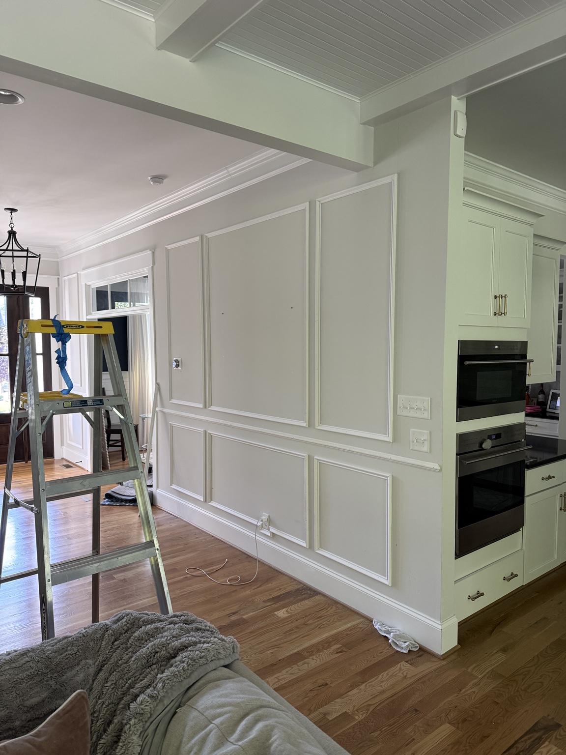 Shadowbox wainscoting above and below the chair rail in a Hallsley foyer in Midlothian, VA