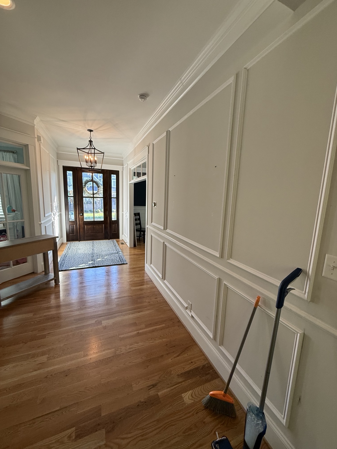 Shadowbox wainscoting above and below the chair rail in a Hallsley foyer in Midlothian, VA