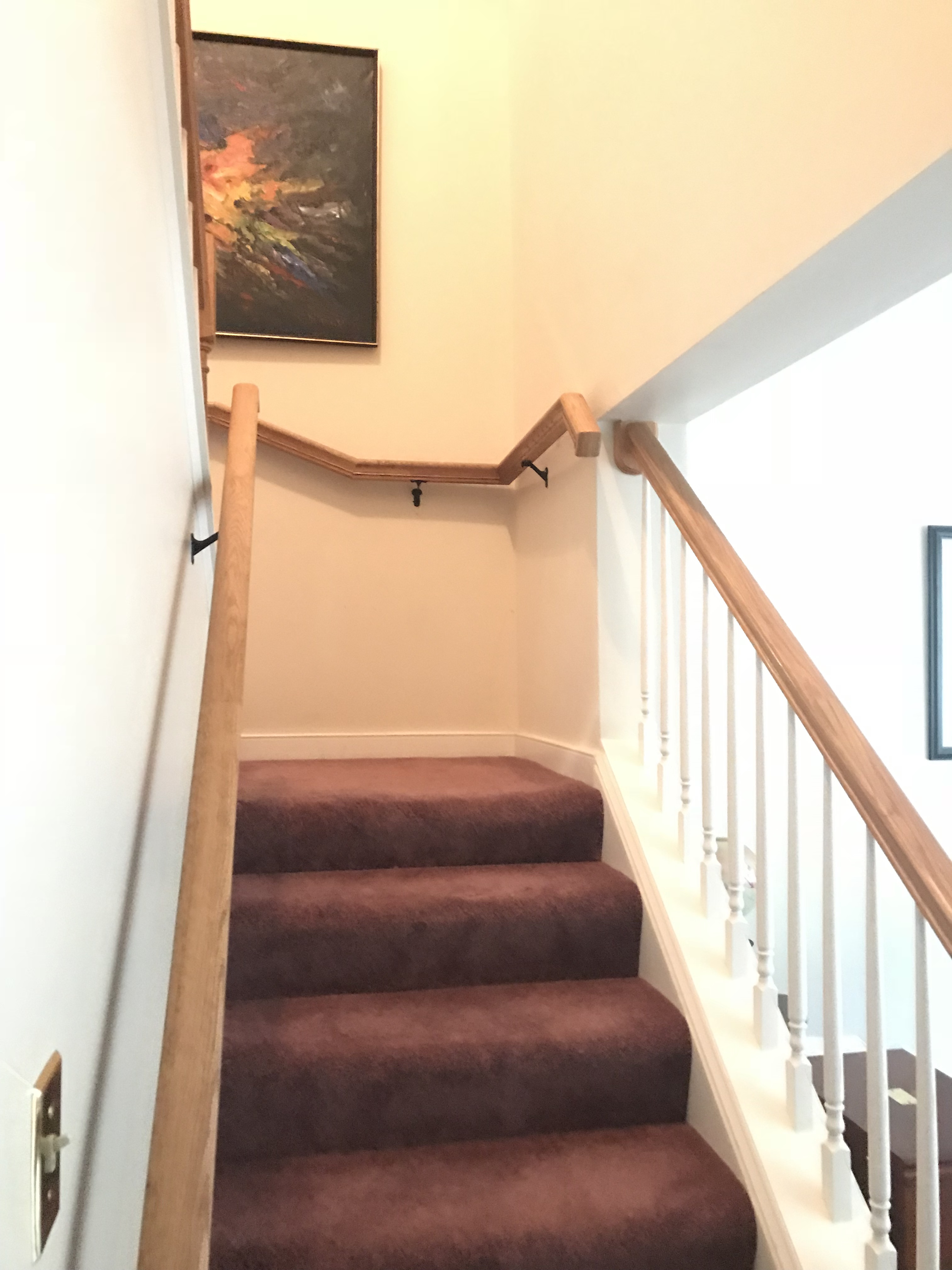 Wood stair pickets upgraded to black iron balusters